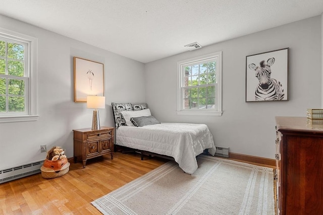 6 Lancaster Pl, Andover, MA 01810 - bedroom featuring light wood-style floors, a baseboard radiator, and baseboards