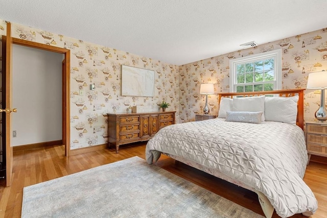 6 Lancaster Pl, Andover, MA 01810 - bedroom with wallpapered walls, wood finished floors, a textured ceiling, and baseboards