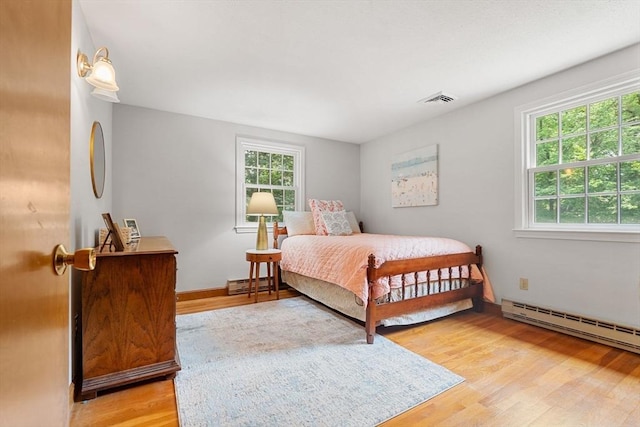 6 Lancaster Pl, Andover, MA 01810 - bedroom with light wood finished floors, baseboard heating, and a baseboard heating unit