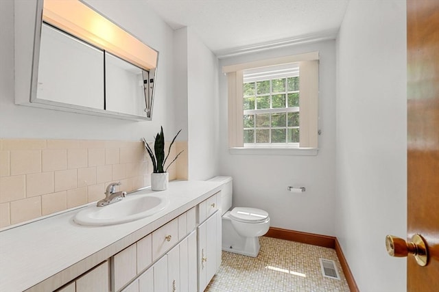 6 Lancaster Pl, Andover, MA 01810 - bathroom with vanity, toilet, tile patterned floors, baseboards, and decorative backsplash