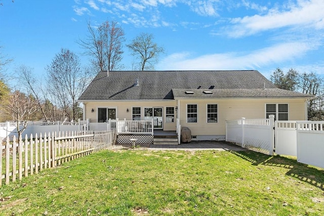 back of property with a wooden deck, a fenced backyard, and a yard
