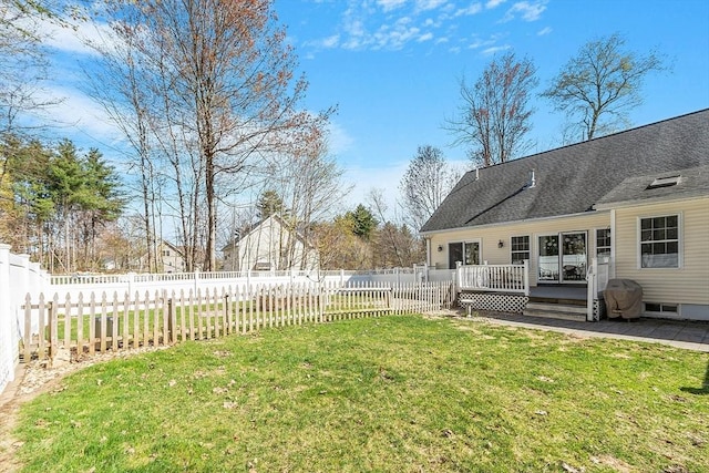 view of yard with a deck and a fenced backyard