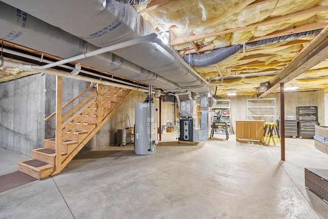 unfinished basement featuring heating unit, water heater, and stairs