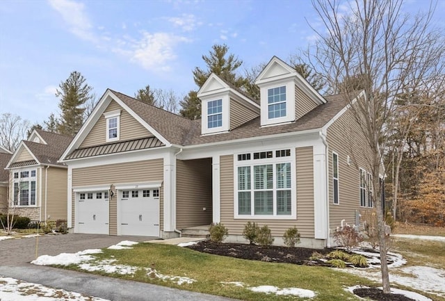 cape cod house featuring a garage