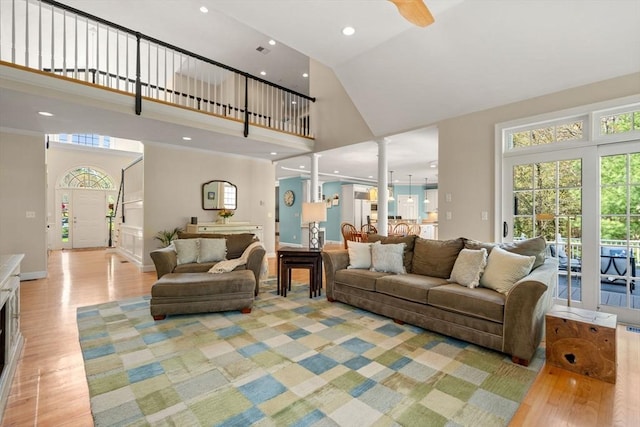living area with high vaulted ceiling, light wood-type flooring, plenty of natural light, recessed lighting, and ceiling fan