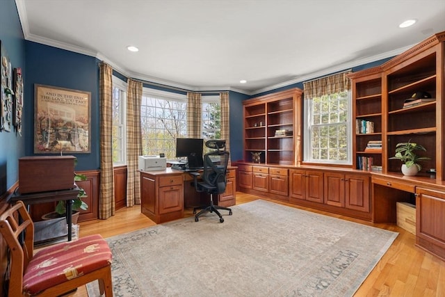 office with ornamental molding, built in desk, light wood finished floors, and recessed lighting