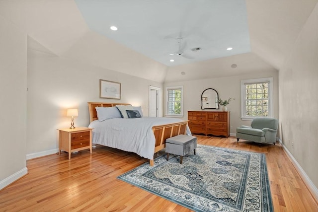 bedroom with multiple windows, light wood-style floors, lofted ceiling, baseboards, and recessed lighting