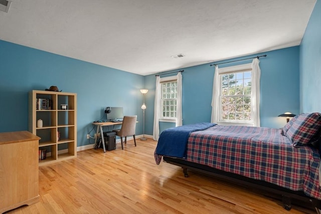 bedroom featuring wood finished floors and baseboards