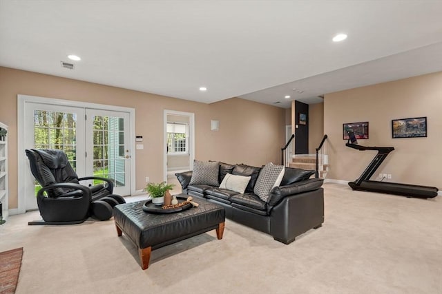 living area with light carpet, recessed lighting, baseboards, and stairway