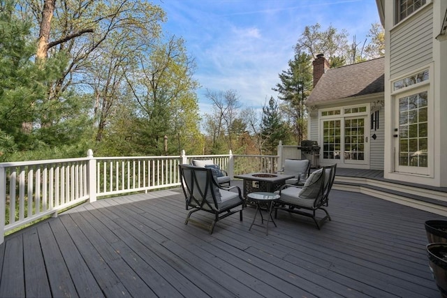 wooden deck with an outdoor fire pit