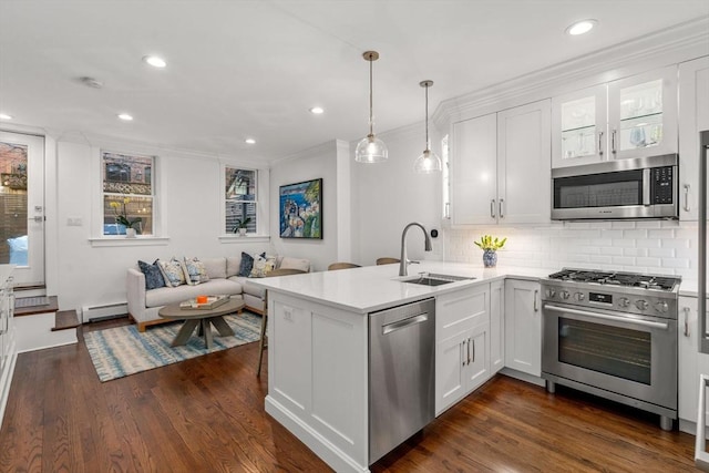 kitchen featuring white cabinets, appliances with stainless steel finishes, light countertops, and a sink