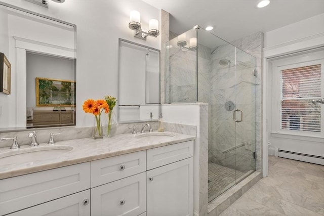 full bath featuring a marble finish shower, double vanity, toilet, and a sink