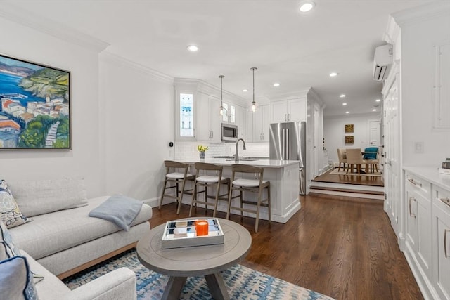 living room with recessed lighting, ornamental molding, dark wood-style flooring, and a wall mounted AC