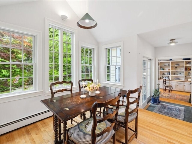 234 Lowell Rd, Wellesley, MA 02481 - dining area featuring a baseboard heating unit, lofted ceiling, healthy amount of natural light, and wood finished floors