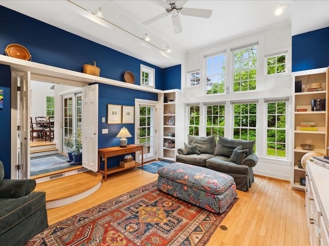 234 Lowell Rd, Wellesley, MA 02481 - living room with light wood-style flooring, ceiling fan, french doors, a high ceiling, and track lighting