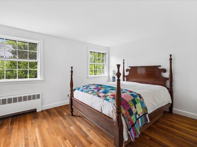234 Lowell Rd, Wellesley, MA 02481 - bedroom with radiator, multiple windows, and wood finished floors