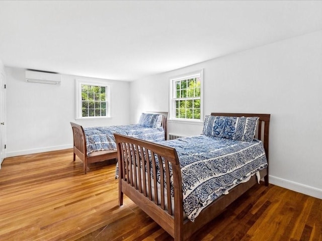 234 Lowell Rd, Wellesley, MA 02481 - bedroom featuring a wall mounted air conditioner, wood finished floors, multiple windows, and baseboards