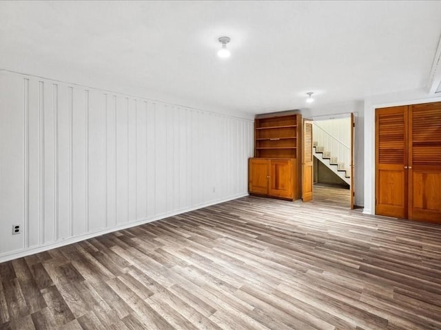 234 Lowell Rd, Wellesley, MA 02481 - unfurnished living room featuring wood finished floors, stairway, and baseboards