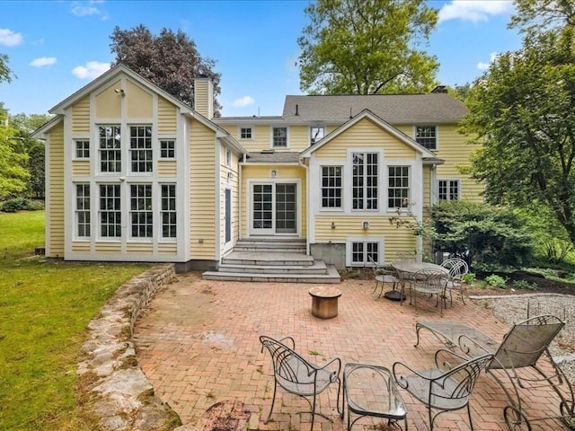 234 Lowell Rd, Wellesley, MA 02481 - rear view of property featuring a patio, a chimney, and a yard