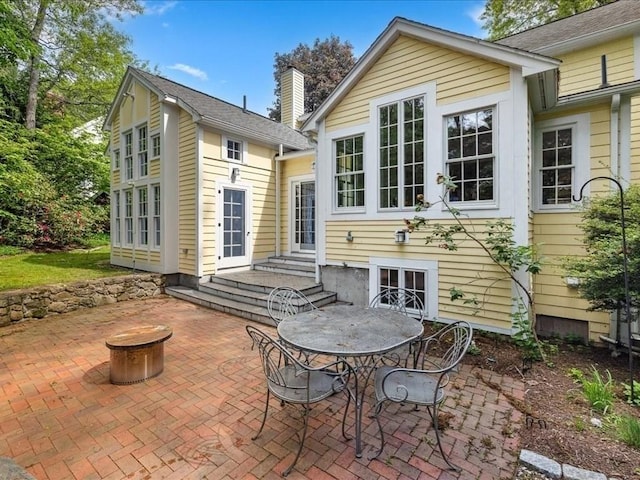 234 Lowell Rd, Wellesley, MA 02481 - back of house featuring a patio, a chimney, and entry steps