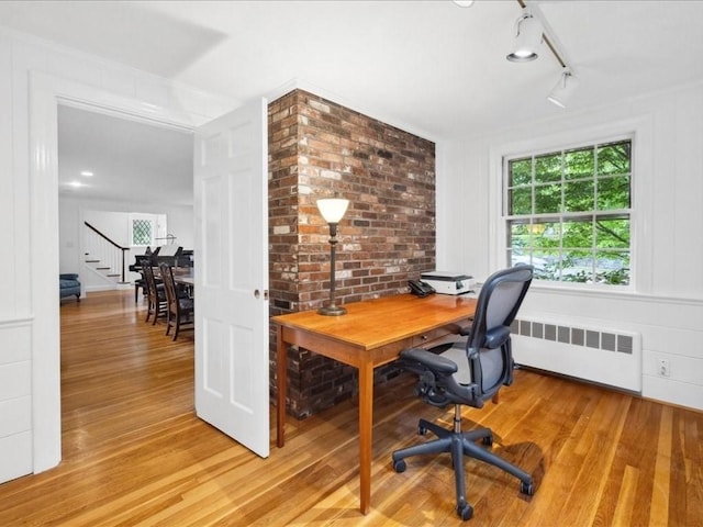 234 Lowell Rd, Wellesley, MA 02481 - office area featuring radiator heating unit, light wood-type flooring, healthy amount of natural light, and rail lighting