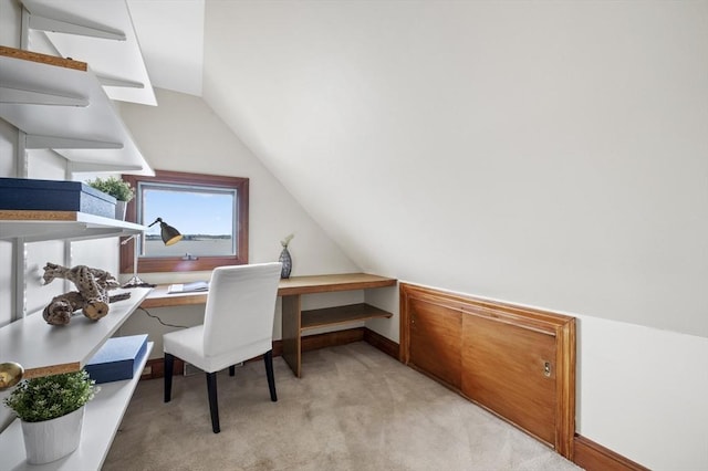 office area with light carpet, lofted ceiling, and baseboards