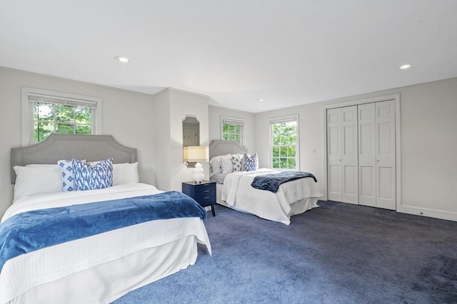 bedroom with recessed lighting, dark carpet, a closet, and baseboards