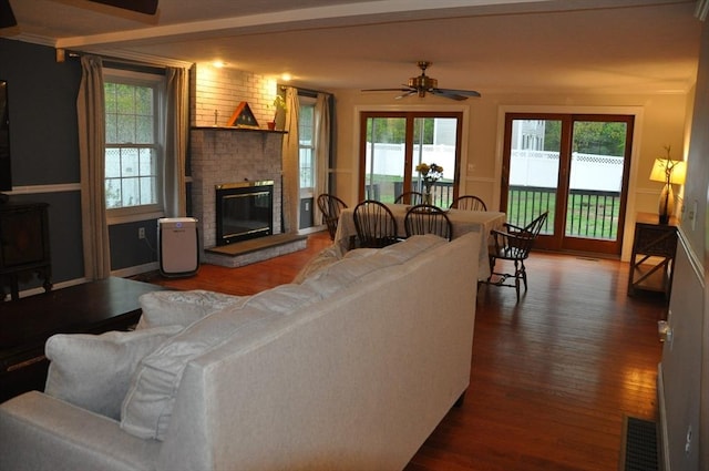 34 Liberty Ln, Ashburnham, MA 01430 - living area featuring dark wood-style floors, a ceiling fan, a brick fireplace, and plenty of natural light