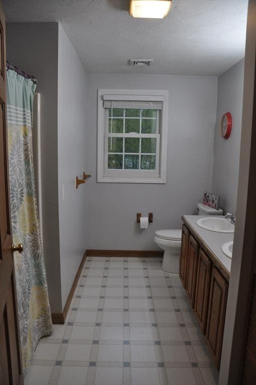 34 Liberty Ln, Ashburnham, MA 01430 - bathroom featuring tile patterned floors, toilet, double vanity, baseboards, and curtained shower