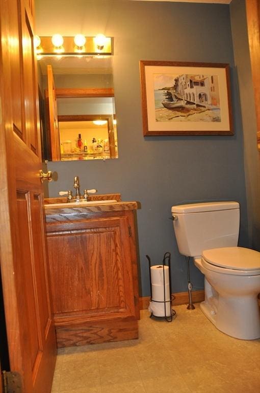 34 Liberty Ln, Ashburnham, MA 01430 - bathroom featuring toilet, vanity, baseboards, and tile patterned flooring