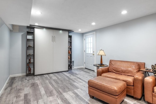 sitting room with recessed lighting, baseboards, and light wood finished floors