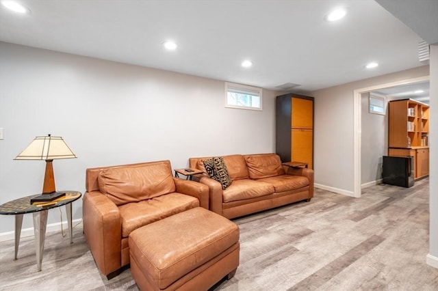 living room featuring baseboards and recessed lighting