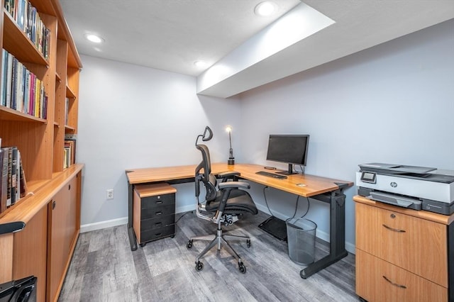 office area featuring light wood finished floors, baseboards, and recessed lighting