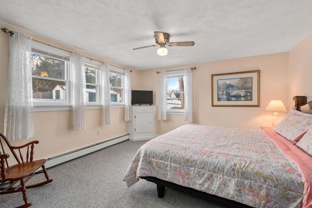 carpeted bedroom with ceiling fan, a textured ceiling, and baseboard heating