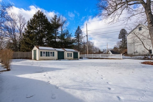 snowy yard featuring an outdoor structure