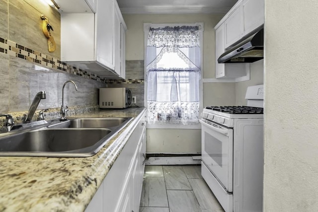 kitchen featuring white range with gas cooktop, under cabinet range hood, a sink, white cabinets, and decorative backsplash