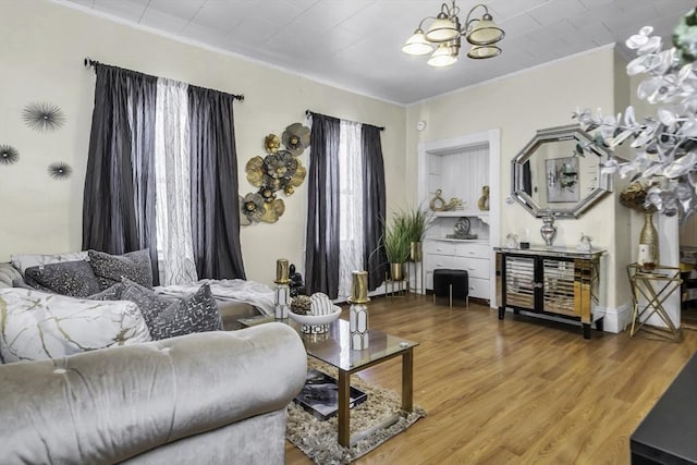 living room featuring a chandelier, wood finished floors, and ornamental molding