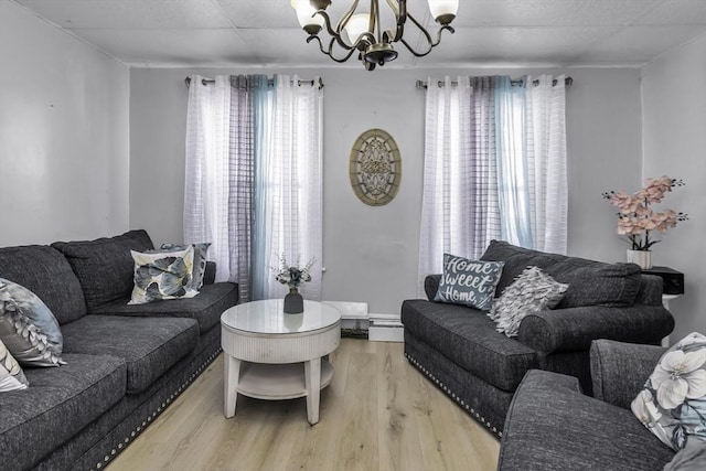living area with a chandelier and wood finished floors