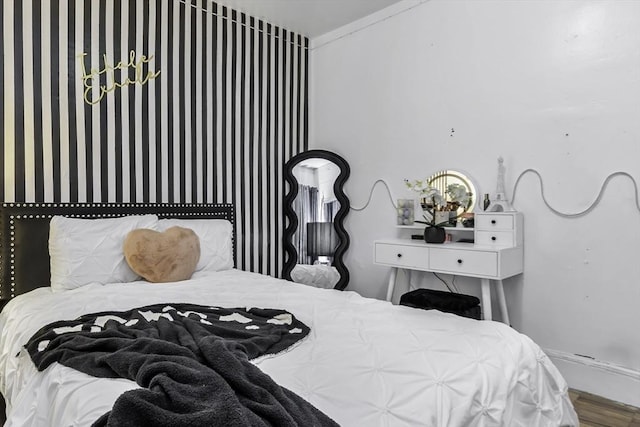 bedroom featuring baseboards and wood finished floors