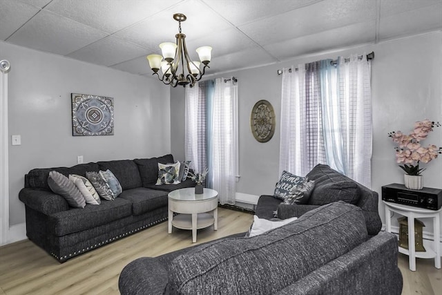 living area featuring a chandelier and wood finished floors