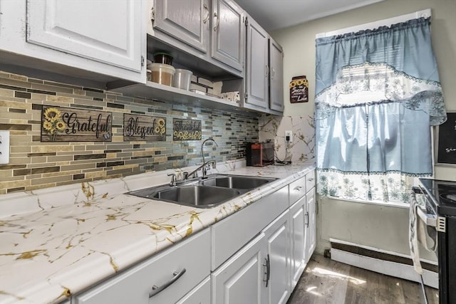 kitchen with a sink, open shelves, plenty of natural light, and decorative backsplash