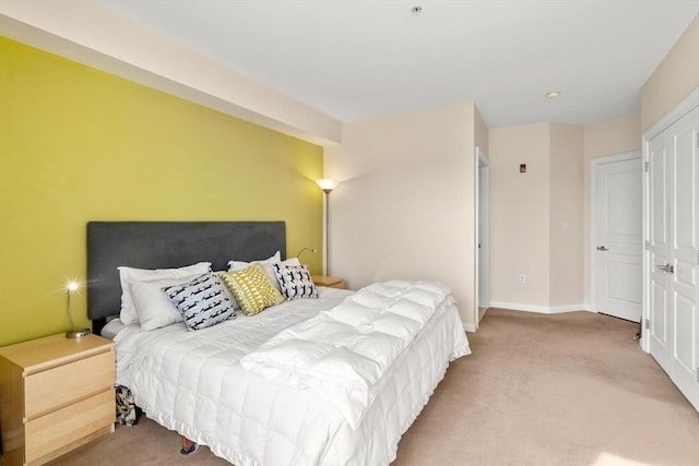 carpeted bedroom featuring baseboards