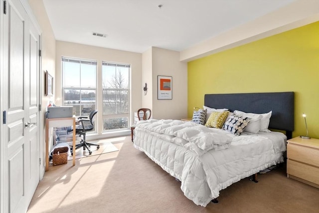 bedroom with light carpet and visible vents