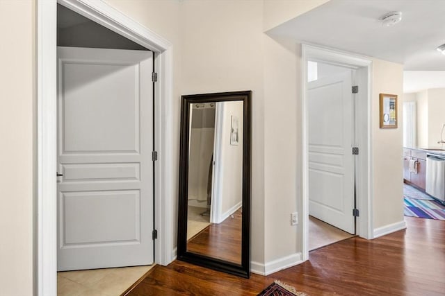 hall with wood finished floors and baseboards