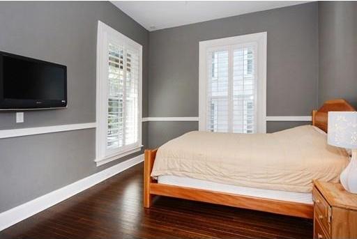 bedroom with dark wood-type flooring