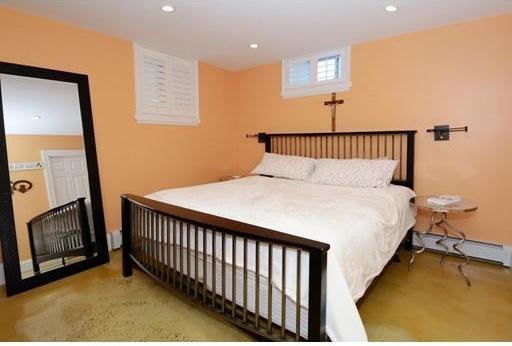 carpeted bedroom with baseboard heating