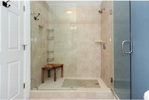 bathroom featuring a shower with shower door