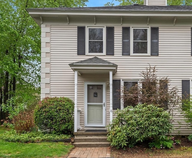 italianate home with roof with shingles