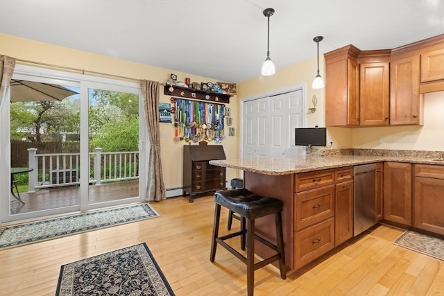 kitchen with stainless steel dishwasher, light wood-style flooring, a peninsula, and brown cabinets