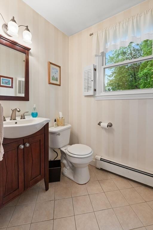 bathroom featuring baseboard heating, toilet, tile patterned floors, and vanity